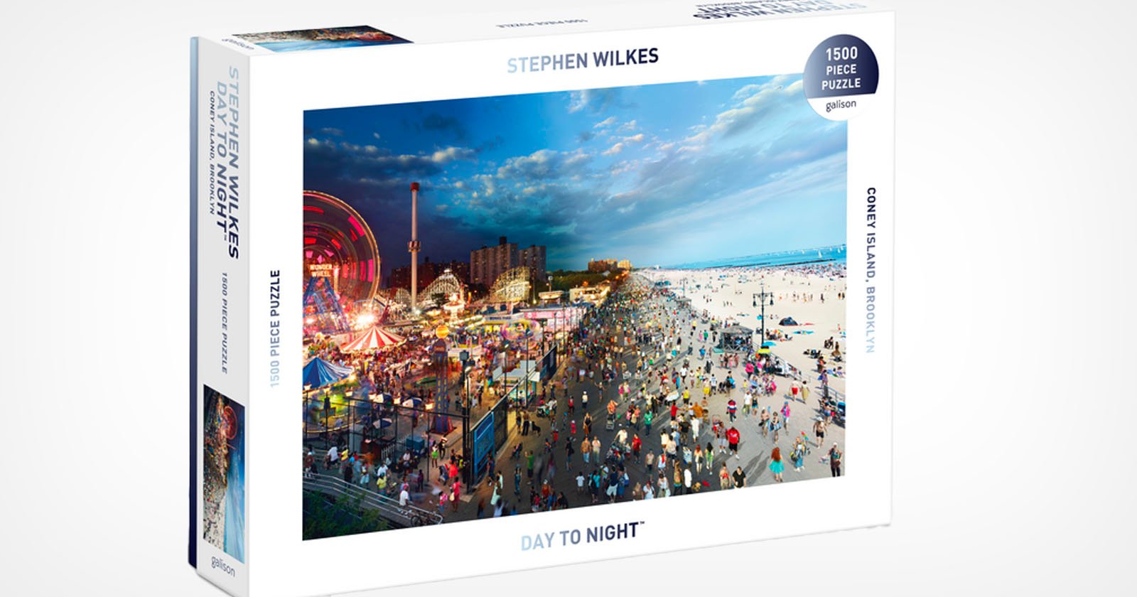 A puzzle box featuring a 1500-piece puzzle titled Day to Night by Stephen Wilkes. The image depicts a vibrant beach and amusement park scene at Coney Island, transitioning from day to night across the photograph.