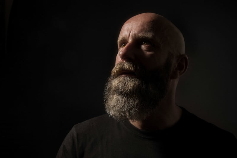 An image of a dark male portrait in classic rembrandt light