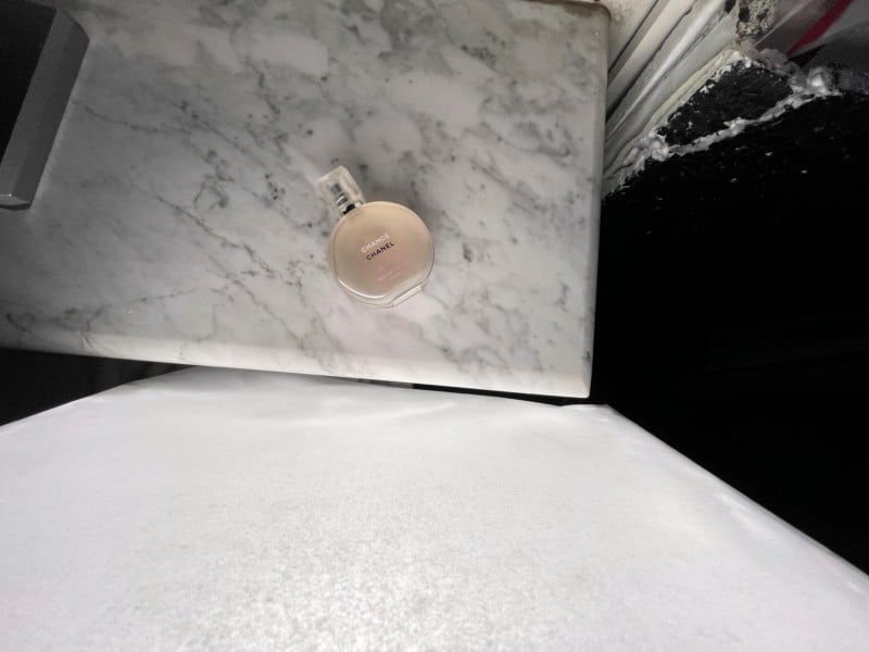 A bottle of perfume on a stone surface