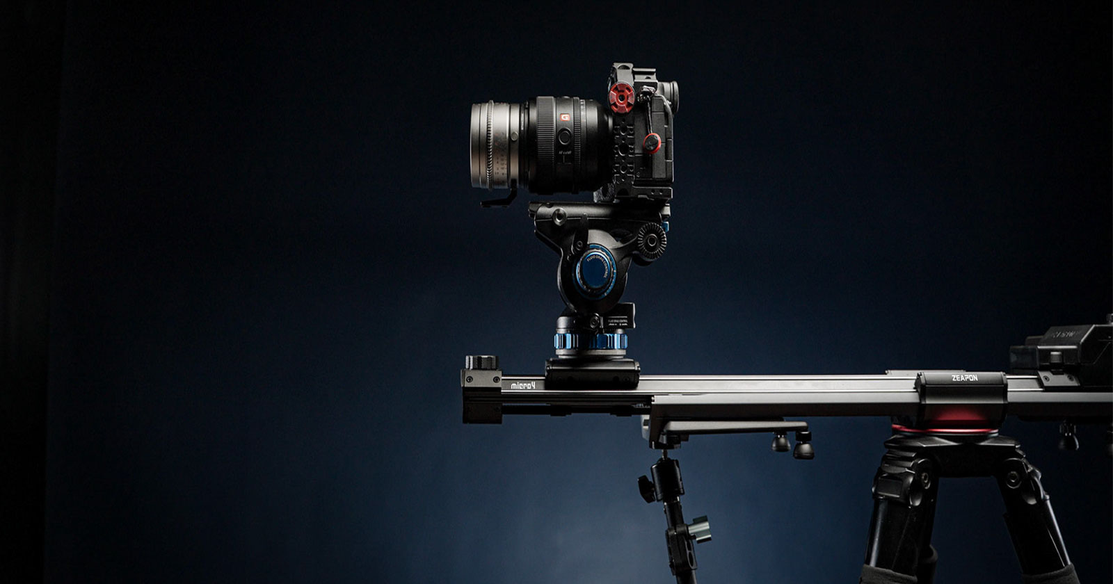 A professional camera mounted on a motorized slider with a sturdy tripod against a dark background. The setup is ready for capturing smooth, cinematic shots.