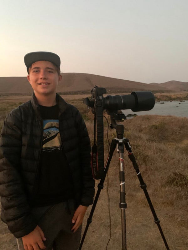 Photographer Lance Wilson standing with his camera and tripod