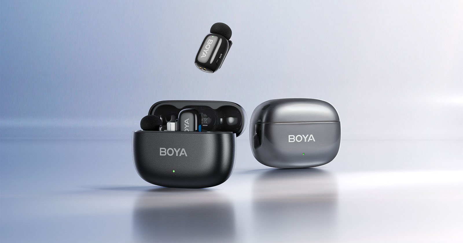 Two black BOYA wireless earbuds cases are shown; one case is open displaying the earbuds inside, while the other case is closed. A single earbud hovers above the open case against a light, reflective background.