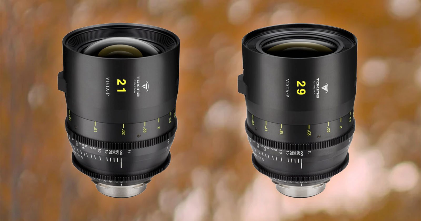 Two camera lenses with black exteriors and green and yellow markings. The lens on the left is labeled 21 and the lens on the right is labeled 29. Both are set against a blurred brown and orange background.