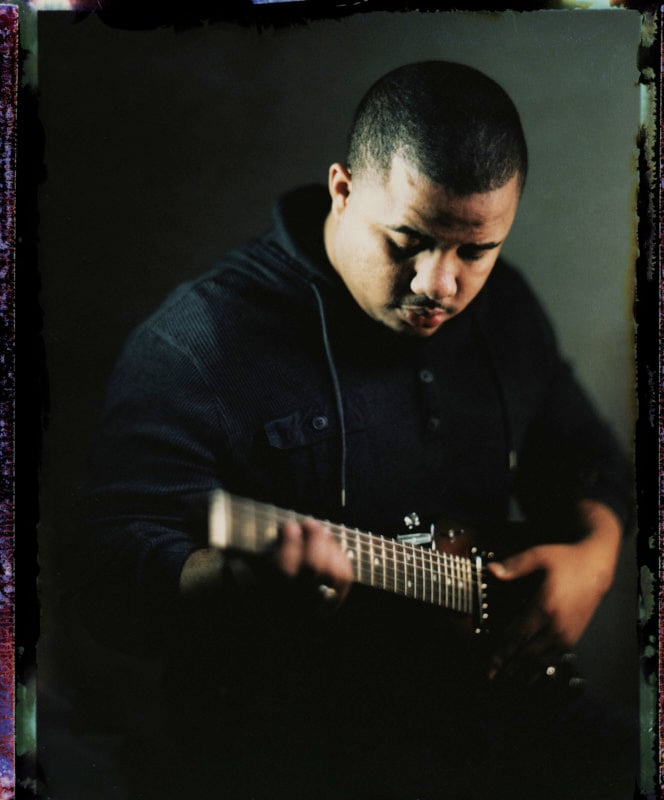 A photo of a man playing a guitar
