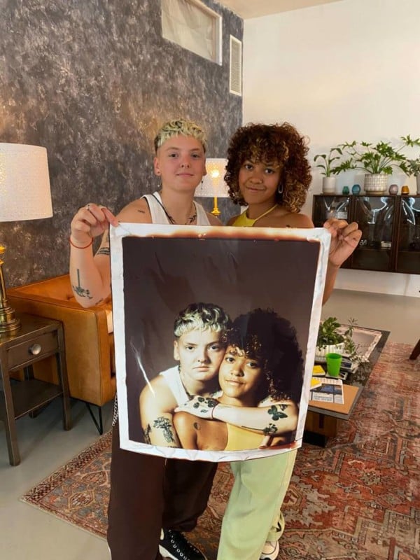 Two women holding a giant 20 by 24 inch instant photo of themselves