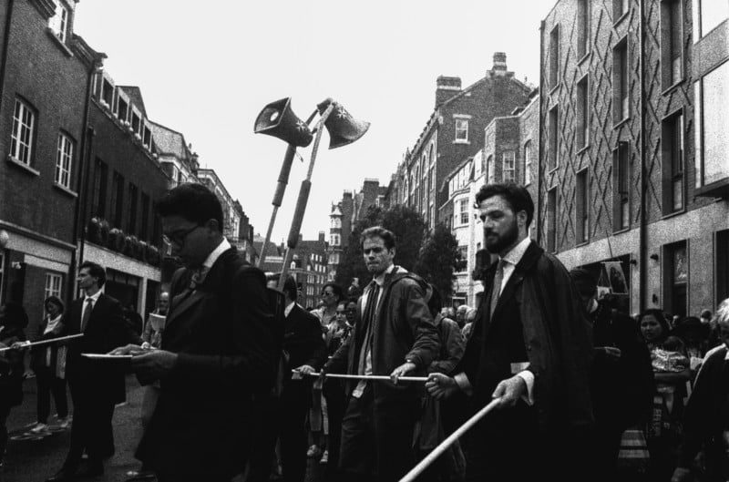 A group of protestors in a street holding sticks A group of protestors in a street holding sticks