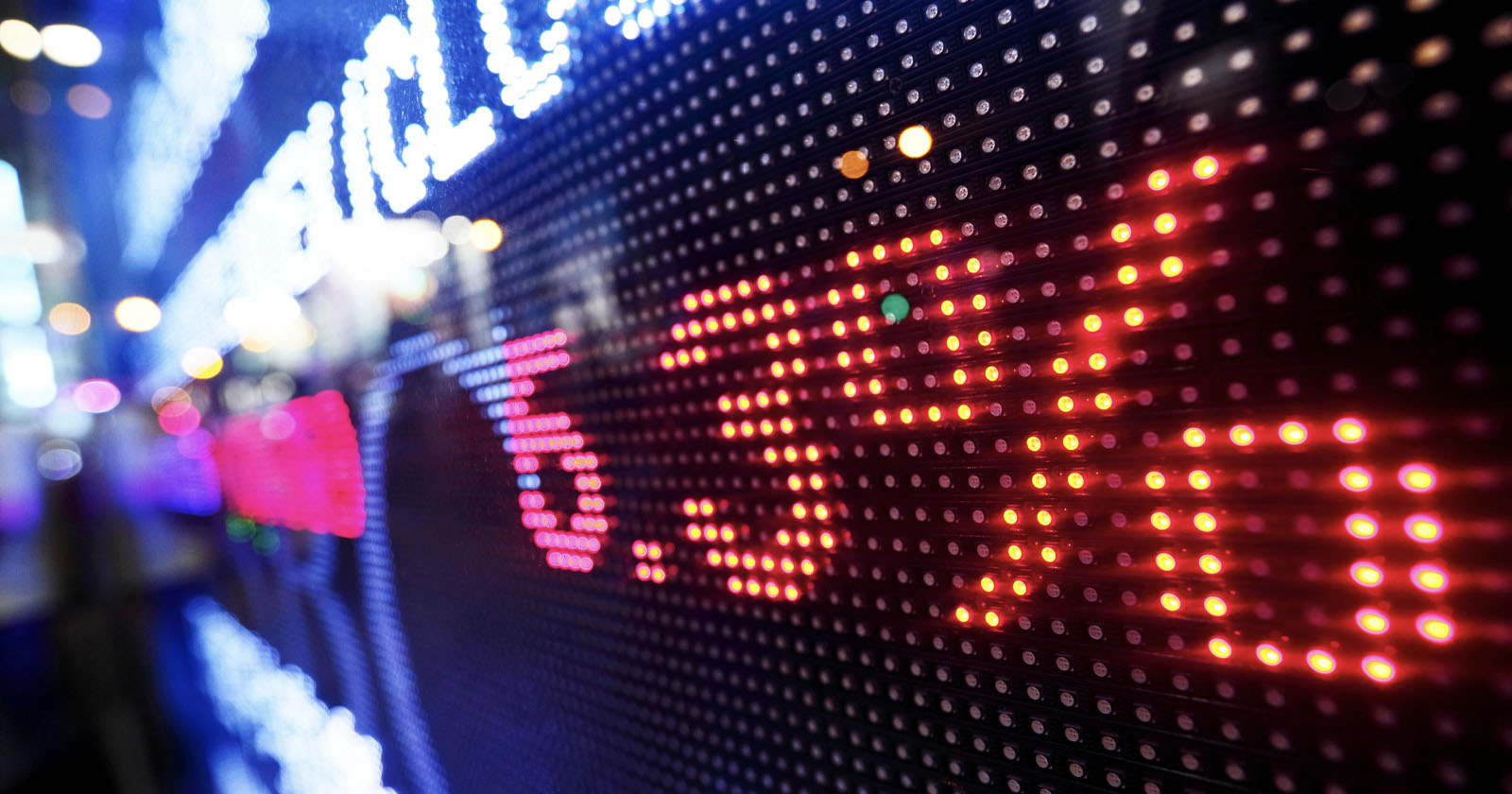 Close-up of an electronic display board showing illuminated numbers and percentages in red and white lights, with a blurred colorful background. The largest visible red text reads 5.3%. The display suggests a financial or stock market context. Close-up of an electronic display board showing illuminated numbers and percentages in red and white lights, with a blurred colorful background. The largest visible red text reads 5.3%. The display suggests a financial or stock market context.