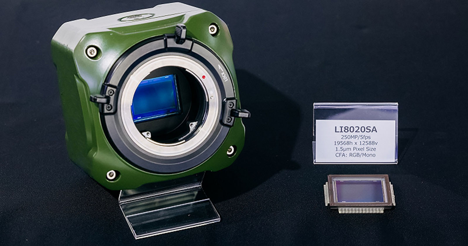 A digital camera sensor labeled LI8020SA is displayed on a stand. The sensor has specifications listed, including 250MP resolution, 19,568 x 12,588 dimensions, 1.5μm pixel size, and CFA: RGB/Mono, alongside a green and silver camera housing. A digital camera sensor labeled LI8020SA is displayed on a stand. The sensor has specifications listed, including 250MP resolution, 19,568 x 12,588 dimensions, 1.5μm pixel size, and CFA: RGB/Mono, alongside a green and silver camera housing.