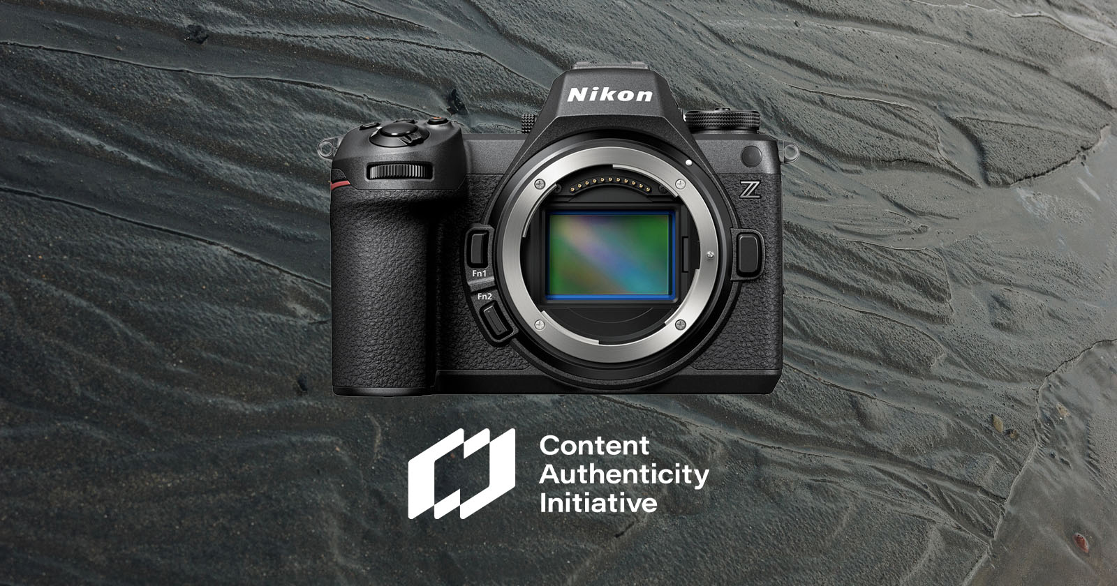 A Nikon Z series camera displayed without a lens against a textured background. The logo for the Content Authenticity Initiative appears below the camera. A Nikon Z series camera displayed without a lens against a textured background. The logo for the Content Authenticity Initiative appears below the camera.