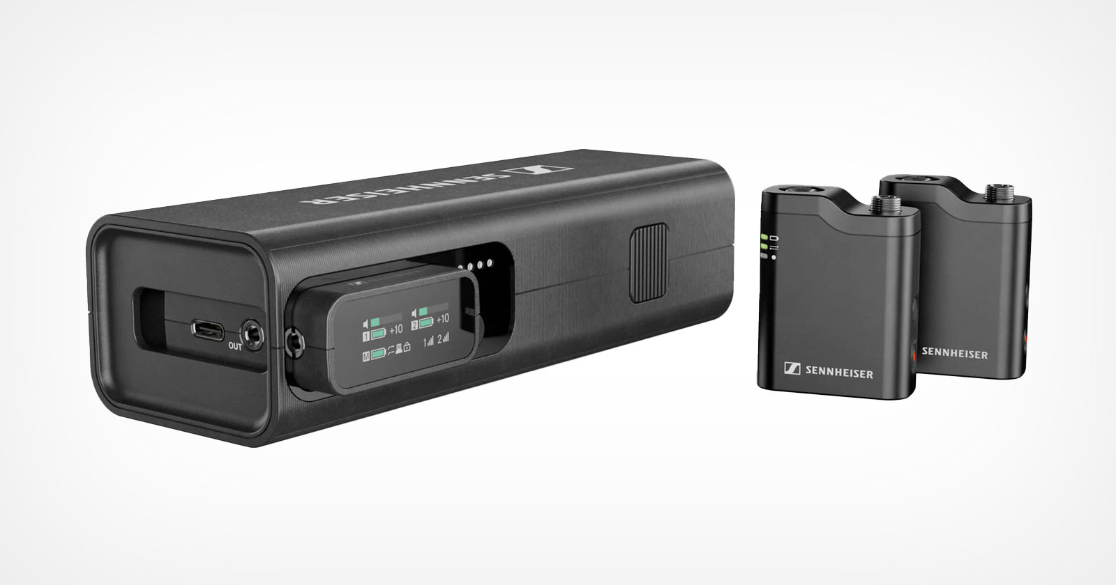 Image of a Sennheiser wireless microphone system showing a rectangular charging case and two compact black transmitters with small screens and labeled buttons. Image of a Sennheiser wireless microphone system showing a rectangular charging case and two compact black transmitters with small screens and labeled buttons.