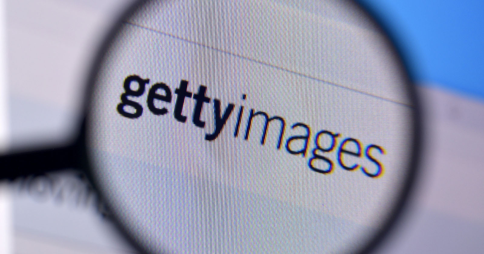 Magnifying glass focusing on the Getty Images logo displayed on a computer screen. The text is clear and prominent, indicating the well-known stock photography company. Magnifying glass focusing on the Getty Images logo displayed on a computer screen. The text is clear and prominent, indicating the well-known stock photography company.