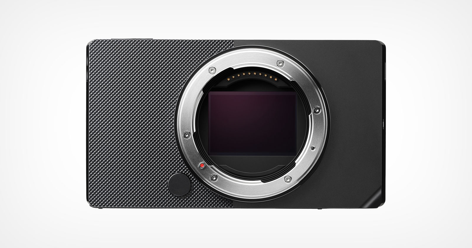 A minimalist black digital camera body with a textured surface, featuring a prominent lens mount in the center. The camera is displayed against a plain light background, showcasing its compact and modern design. A minimalist black digital camera body with a textured surface, featuring a prominent lens mount in the center. The camera is displayed against a plain light background, showcasing its compact and modern design.