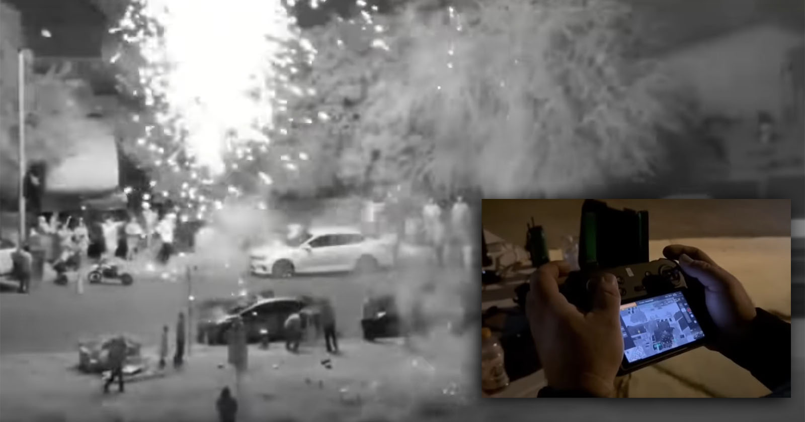 A nighttime street scene shows fireworks exploding near a crowd and parked cars. Inset at the lower right, hands hold a controller, viewing a live camera feed of the event. A nighttime street scene shows fireworks exploding near a crowd and parked cars. Inset at the lower right, hands hold a controller, viewing a live camera feed of the event.