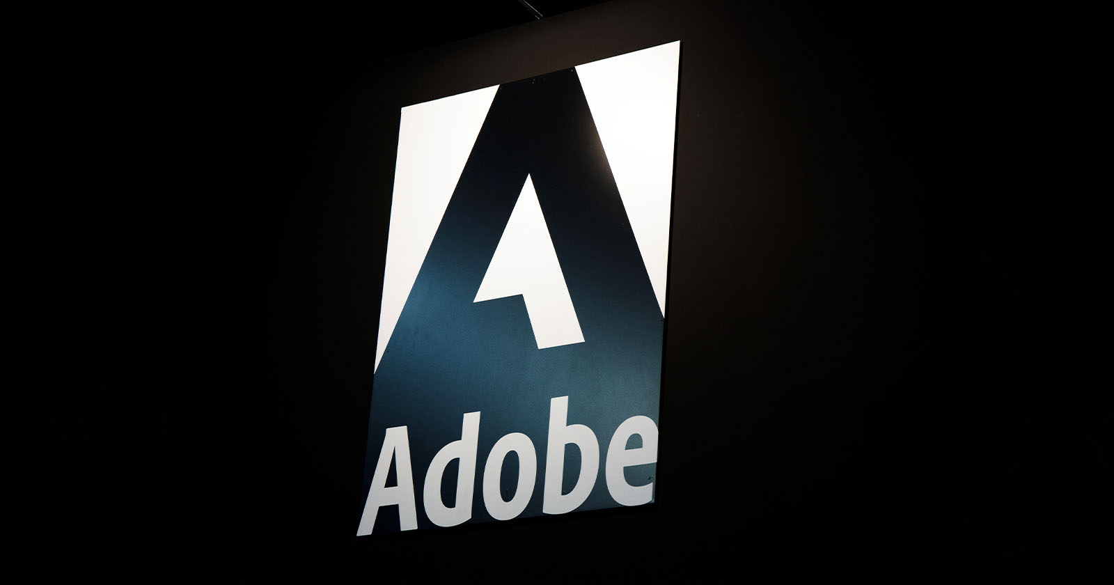 The image shows the Adobe logo, featuring a large stylized white A on a dark background with the word Adobe written below it in bold white letters. The image shows the Adobe logo, featuring a large stylized white A on a dark background with the word Adobe written below it in bold white letters.